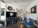 Open living and dining area with wood floors and large TV at 2400 E Baseline Ave # 301, Apache Junction, AZ 85119