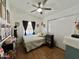 Cozy bedroom with double bed, wood floors, and ceiling fan at 2400 E Baseline Ave # 301, Apache Junction, AZ 85119