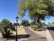 Landscaped walking path with mature trees and lighting at 2400 E Baseline Ave # 301, Apache Junction, AZ 85119