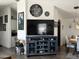 Open living and dining area with wood floors and large TV at 2400 E Baseline Ave # 301, Apache Junction, AZ 85119