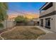 Landscaped backyard with a grassy area and brick pavers at 2333 S 173Rd Ln, Goodyear, AZ 85338