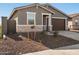 Gray exterior, stone accents, and two-car garage at 17407 W Sanna St, Waddell, AZ 85355