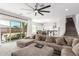 Spacious living room featuring a sectional sofa, sliding glass doors to the backyard, and an open floor plan at 8823 W Wagon Wheel Dr, Glendale, AZ 85305