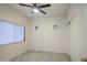 Well-lit bedroom with tile floors and double closets at 13729 W Country Gables Dr, Surprise, AZ 85379