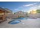 Inviting backyard oasis featuring a sparkling pool, spa, and waterfall feature at 13729 W Country Gables Dr, Surprise, AZ 85379