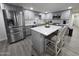 Modern kitchen with gray cabinets, stainless steel appliances and an island at 9017 E Butternut Ave, Mesa, AZ 85208