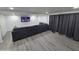 Living room with gray sectional sofa, large TV, and gray curtains at 9017 E Butternut Ave, Mesa, AZ 85208