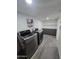 Laundry room with washer, dryer and storage shelving at 9017 E Butternut Ave, Mesa, AZ 85208