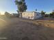 Exterior view of a manufactured home with a large lot and desert landscaping at 9017 E Butternut Ave, Mesa, AZ 85208