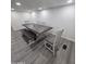 Dining area featuring a large gray wood table with bench seating at 9017 E Butternut Ave, Mesa, AZ 85208