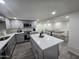 Modern kitchen with gray cabinets, island, and stainless steel appliances at 9017 E Butternut Ave, Mesa, AZ 85208