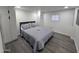 Bedroom featuring a gray bed, built-in closet, and gray flooring at 9017 E Butternut Ave, Mesa, AZ 85208
