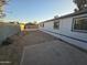 Backyard view of manufactured home with a large lot and a concrete patio at 9017 E Butternut Ave, Mesa, AZ 85208