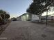 Mobile home with covered porch, driveway and fenced yard at 9017 E Butternut Ave, Mesa, AZ 85208