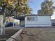 Mobile home with covered porch, side yard and driveway at 9017 E Butternut Ave, Mesa, AZ 85208