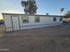 Exterior view of a manufactured home with gray trim and a white exterior at 9017 E Butternut Ave, Mesa, AZ 85208