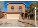 Two-story home with a beige exterior and a two-car garage at 26207 N 47Th Pl, Phoenix, AZ 85050