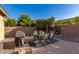 Backyard patio with table, chairs, and grill at 2299 E Saddlebrook Rd, Gilbert, AZ 85298