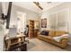 Home office features built-in shelving, a large desk, and comfortable seating at 2299 E Saddlebrook Rd, Gilbert, AZ 85298