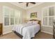 Charming bedroom with wood framed bed and plantation shutters at 2299 E Saddlebrook Rd, Gilbert, AZ 85298