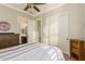 Bright bedroom with striped bedding and built-in closet at 2299 E Saddlebrook Rd, Gilbert, AZ 85298