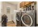 Laundry room includes washer, dryer, and extra storage at 2299 E Saddlebrook Rd, Gilbert, AZ 85298