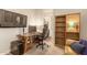 Home office featuring a large desk, comfortable chair and built-in shelves at 2299 E Saddlebrook Rd, Gilbert, AZ 85298