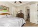 Spacious bedroom with wood dresser and access to en-suite bathroom at 2299 E Saddlebrook Rd, Gilbert, AZ 85298