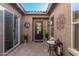 Inviting courtyard entry with brick pavers and potted plants at 2299 E Saddlebrook Rd, Gilbert, AZ 85298