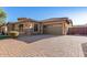 Home exterior with paver driveway and three-car garage at 2299 E Saddlebrook Rd, Gilbert, AZ 85298