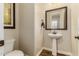 Stylish powder room with pedestal sink and dark wood vanity at 2299 E Saddlebrook Rd, Gilbert, AZ 85298