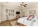 Main bedroom with king-size bed, TV, and ceiling fan at 2299 E Saddlebrook Rd, Gilbert, AZ 85298