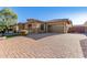 Home exterior with paver driveway and three-car garage at 2299 E Saddlebrook Rd, Gilbert, AZ 85298