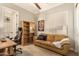 Home office features built-in shelving, a large desk, and comfortable seating at 2299 E Saddlebrook Rd, Gilbert, AZ 85298