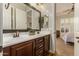Double vanity bathroom with dark wood cabinets and a large mirror at 2299 E Saddlebrook Rd, Gilbert, AZ 85298