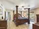 Spacious main bedroom with a large four-poster bed and access to the patio at 14679 N Love Ct, Fountain Hills, AZ 85268