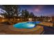 Relaxing freeform pool with a water feature and patio at 22938 S 193Rd St, Queen Creek, AZ 85142