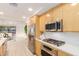 Modern kitchen with stainless steel appliances and light wood cabinets at 7117 E Rancho Vista Dr # 2005, Scottsdale, AZ 85251