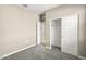 Bright bedroom with sliding door closet and carpet flooring at 1471 S 239Th Dr, Buckeye, AZ 85326