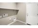 Laundry room with built-in shelving and a door at 1471 S 239Th Dr, Buckeye, AZ 85326