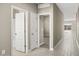 Hallway with tile flooring, leading to bedrooms and a bathroom at 1471 S 239Th Dr, Buckeye, AZ 85326