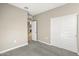 Well-lit bedroom with a sliding door closet and carpet flooring at 1471 S 239Th Dr, Buckeye, AZ 85326