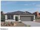 New single story home with a two-car garage and desert landscaping at 1471 S 239Th Dr, Buckeye, AZ 85326
