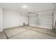 Garage with open garage door and freshly poured floor at 1471 S 239Th Dr, Buckeye, AZ 85326