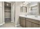 Double vanity bathroom with modern fixtures and large mirrors at 1471 S 239Th Dr, Buckeye, AZ 85326