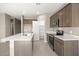 Modern kitchen with island, stainless steel appliances, and pantry at 1471 S 239Th Dr, Buckeye, AZ 85326