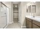 Bright bathroom with double vanity, shower, and walk-in closet at 1471 S 239Th Dr, Buckeye, AZ 85326