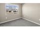 Bright bedroom with carpet flooring and a view of the neighborhood at 1471 S 239Th Dr, Buckeye, AZ 85326
