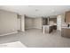Open floor plan with modern kitchen featuring an island and tile flooring at 1471 S 239Th Dr, Buckeye, AZ 85326