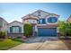 Two-story home with a blue garage door and landscaping at 775 E Leslie Ave, San Tan Valley, AZ 85140